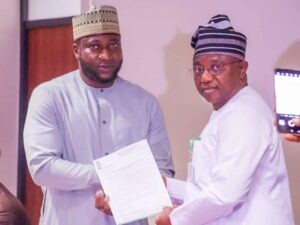 Hon. SEA presenting Appointment Letter to the Chairman of the Committee, Hon. Yusuf Balogun